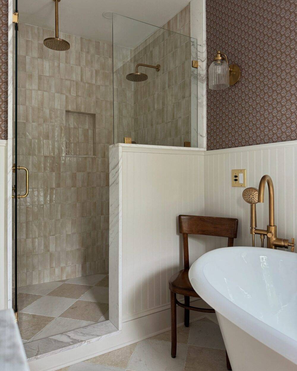 This serene shower features beige handmade-look subway tile walls and a beige and white marble checkerboard tile floor.
