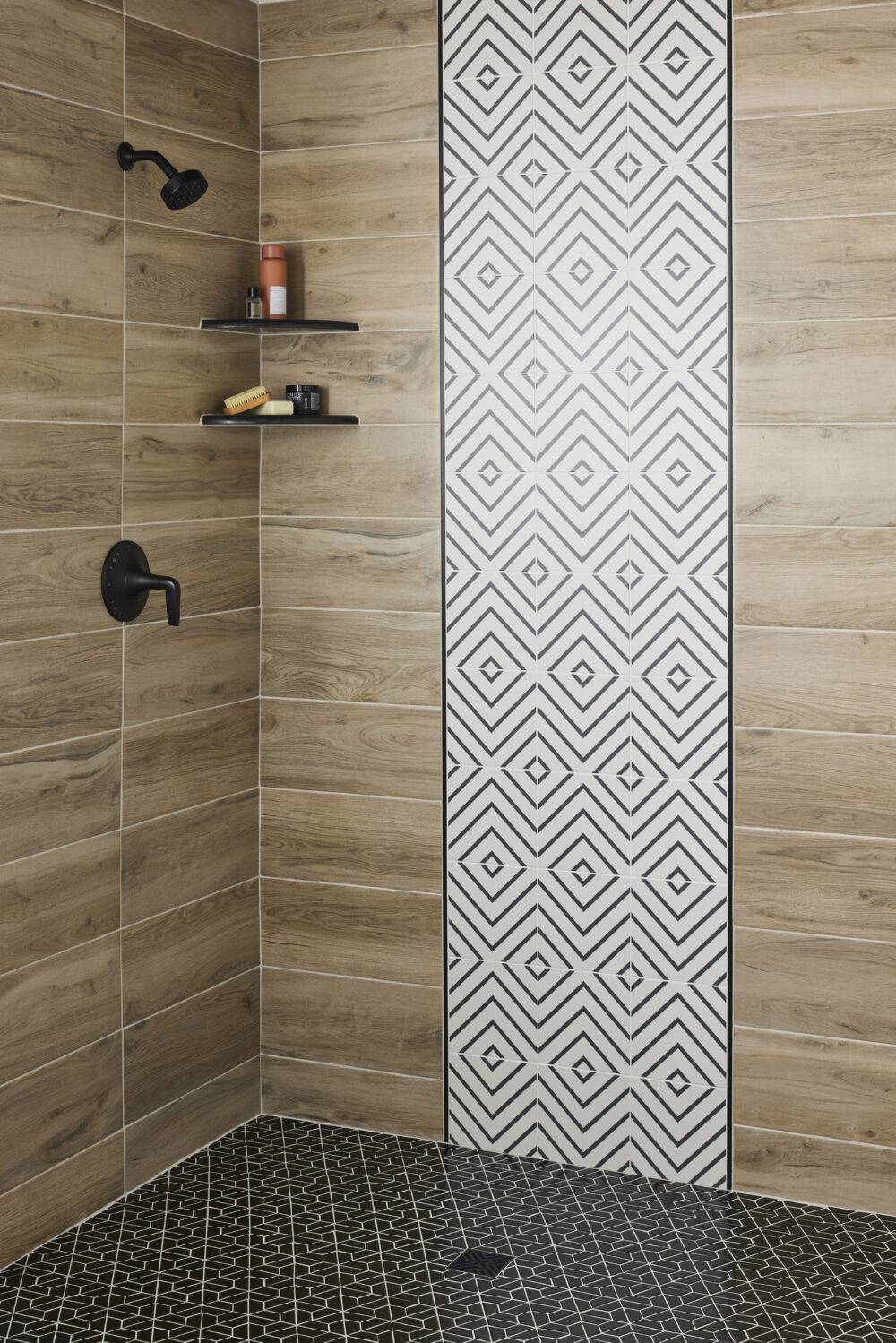 This contemporary shower features wood-look porcelain tile and a band of white with black lined diamond-patterned tile and black half-hexagon mosaic tile floor.