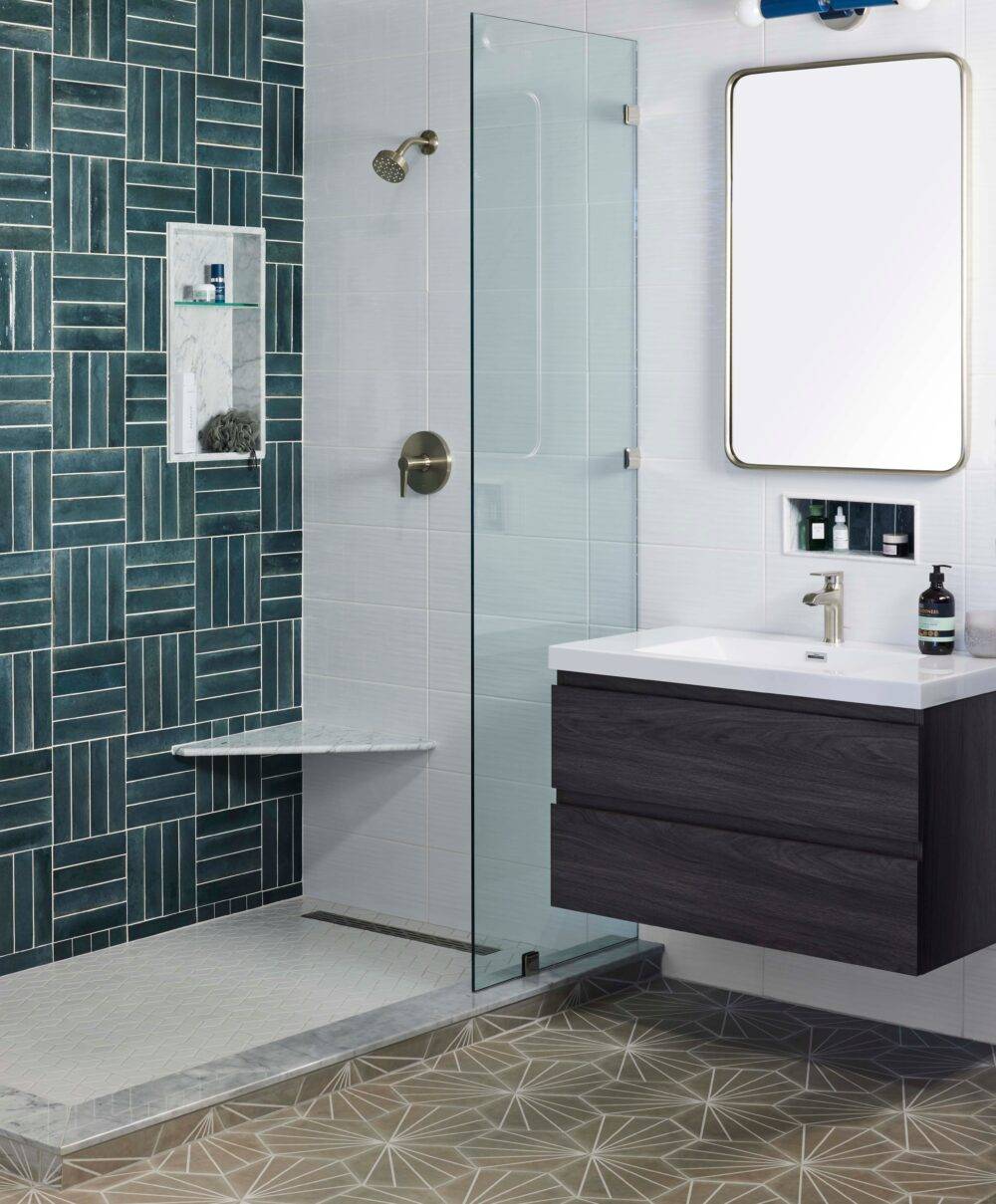 This chic modern bathroom features blue subway tile in a grid-shaped pattern and geometric-patterned hex floor.