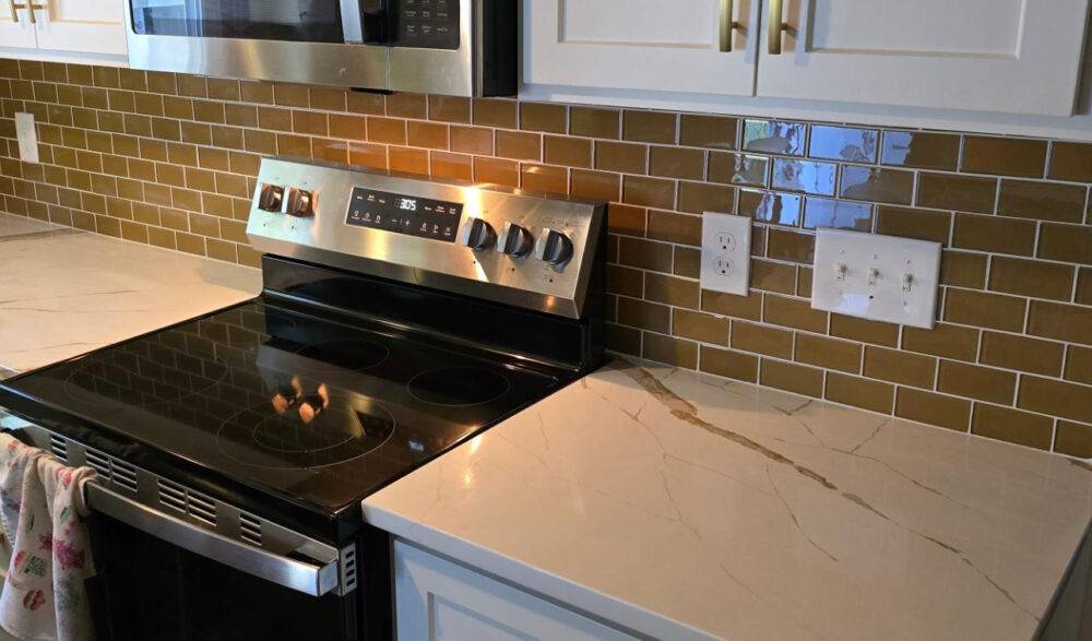 This stylish kitchen features a soft brown subway tile backsplash.