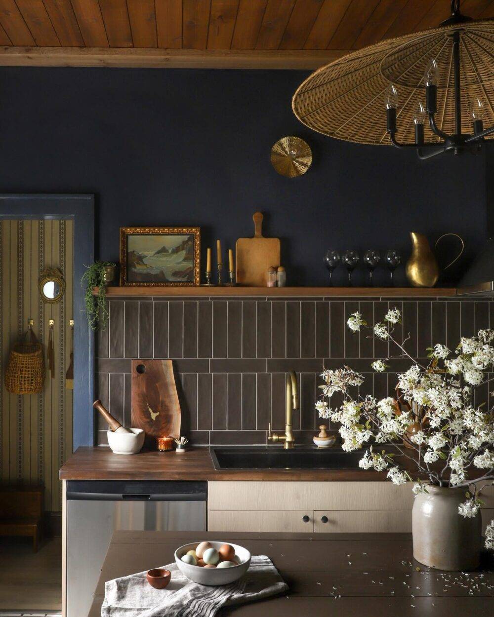 This boho chic kitchen features a dark brown subway tile backsplash in a mix of vertical and horizontal stack.