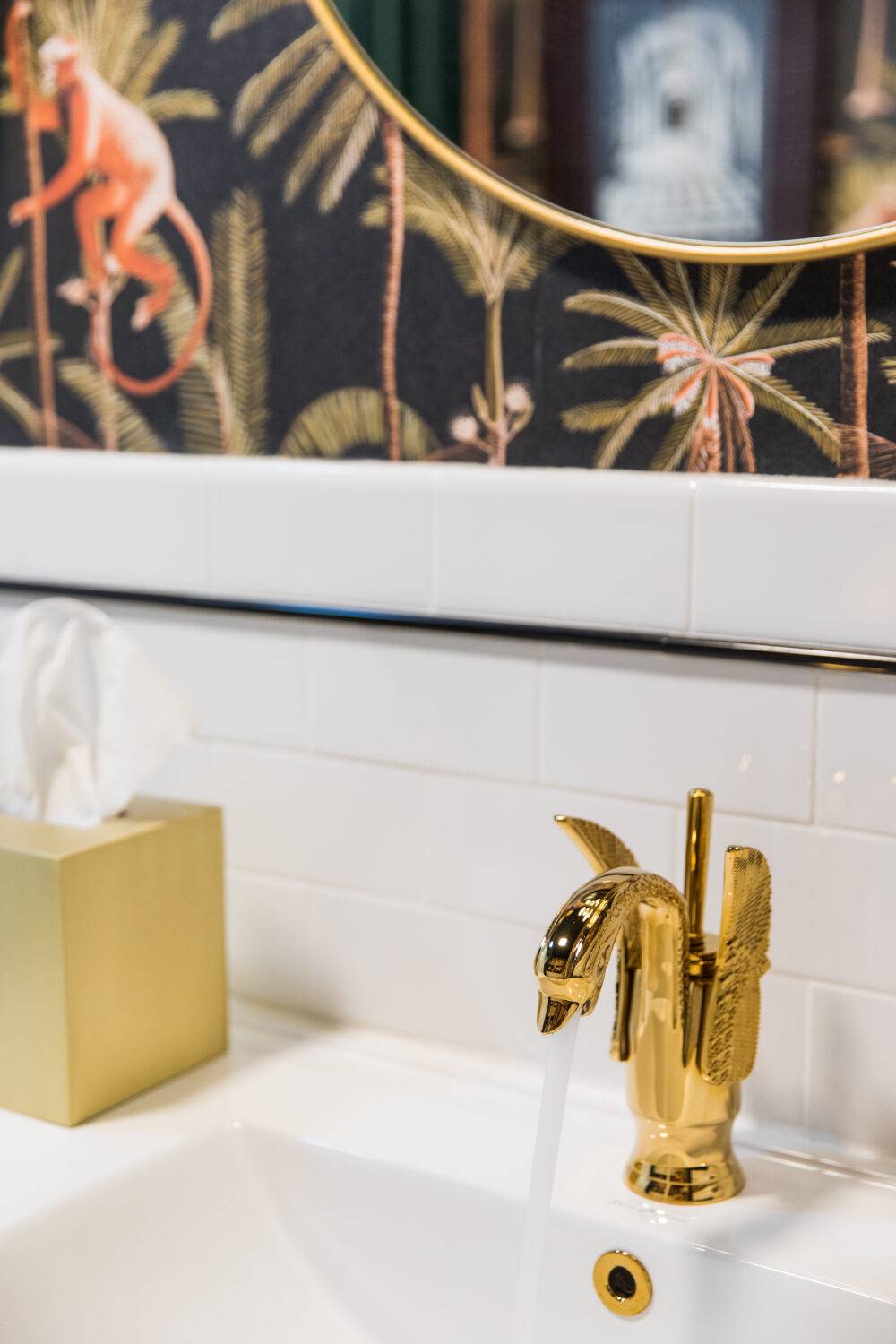 This funky bathroom features a white subway tile backsplash with a black pencil trim.